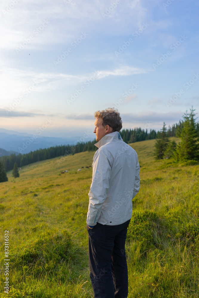 man on a hill overlooking a mountain range, against the background of mountains, tourism, hiking, time together, family, relationships, nature of the Carpathian, vacation, outdoor activities, meditati man on a hill overlooking a mountain range, against the background of mountains, tourism, hiking, time together, family, relationships, nature of the Carpathian, vacation, outdoor activities, meditati