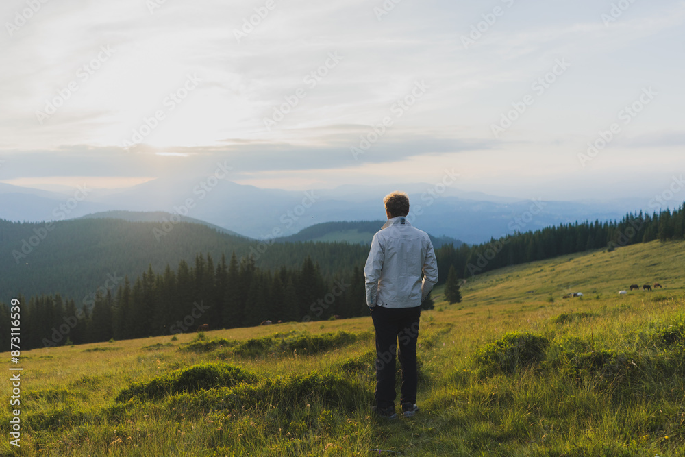 man on a hill overlooking a mountain range, against the background of mountains, tourism, hiking, time together, family, relationships, nature of the Carpathian, vacation, outdoor activities, meditati man on a hill overlooking a mountain range, against the background of mountains, tourism, hiking, time together, family, relationships, nature of the Carpathian, vacation, outdoor activities, meditati