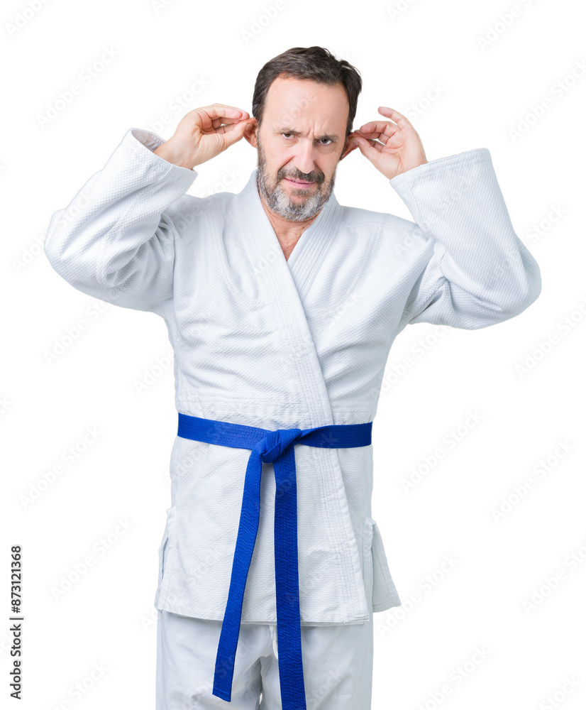 Handsome middle age senior man wearing kimono uniform over isolated background Smiling pulling ears with fingers, funny gesture. Audition problem Handsome middle age senior man wearing kimono uniform over isolated background Smiling pulling ears with fingers, funny gesture. Audition problem