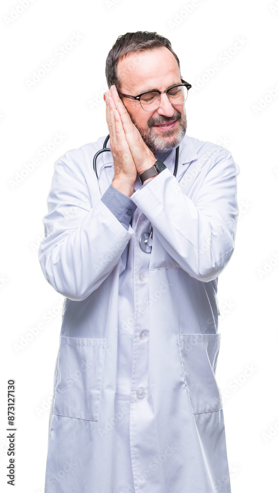 Middle age senior hoary doctor man wearing medical uniform isolated background sleeping tired dreaming and posing with hands together while smiling with closed eyes. Middle age senior hoary doctor man wearing medical uniform isolated background sleeping tired dreaming and posing with hands together while smiling with closed eyes.