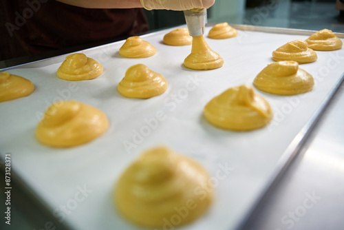 Pretty circles from pastry dough lying on baking paper photo