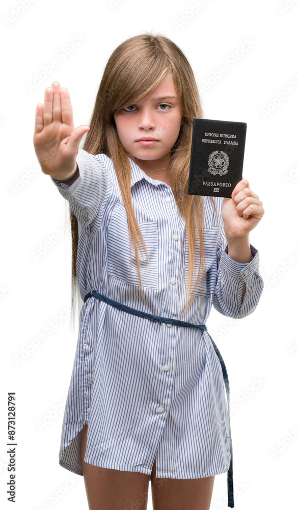 Young blonde toddler holding italian passport with open hand doing stop sign with serious and confident expression, defense gesture Young blonde toddler holding italian passport with open hand doing stop sign with serious and confident expression, defense gesture