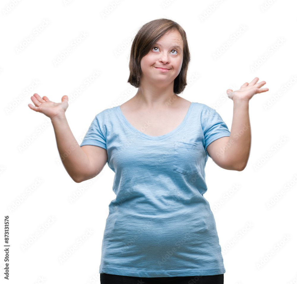 Young adult woman with down syndrome over isolated background clueless and confused expression with arms and hands raised. Doubt concept. Young adult woman with down syndrome over isolated background clueless and confused expression with arms and hands raised. Doubt concept.