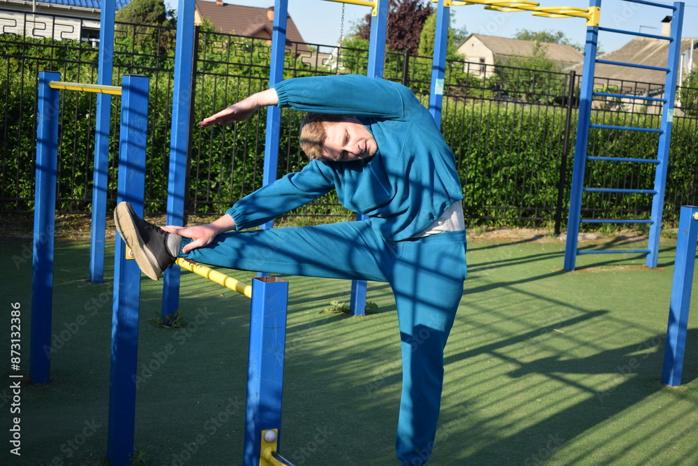 A young man in athletic wear performs morning workout routine at an outdoor gym. He trains diligently on various fitness equipment, building strength endurance, to prepare his body at the sport area A young man in athletic wear performs morning workout routine at an outdoor gym. He trains diligently on various fitness equipment, building strength endurance, to prepare his body at the sport area