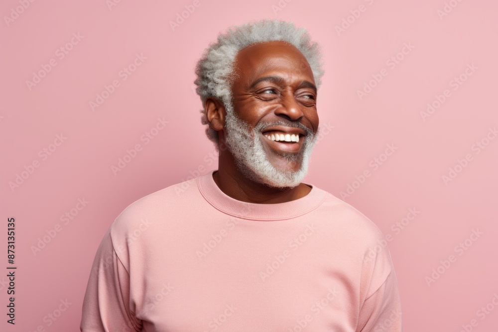 Portrait of a joyful afro-american man in his 60s sporting a long-sleeved thermal undershirt isolated on pastel gray background Portrait of a joyful afro-american man in his 60s sporting a long-sleeved thermal undershirt isolated on pastel gray background