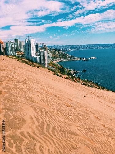 Impeccable dunes with the city and the beach photo