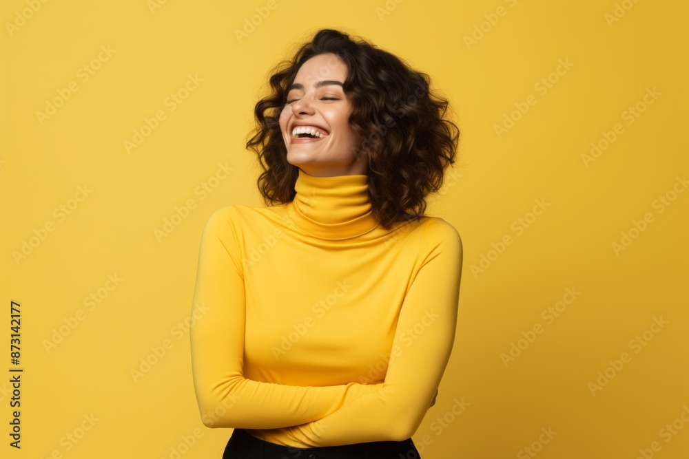 Fototapeta premium Portrait of a joyful woman in her 30s wearing a classic turtleneck sweater while standing against soft yellow background