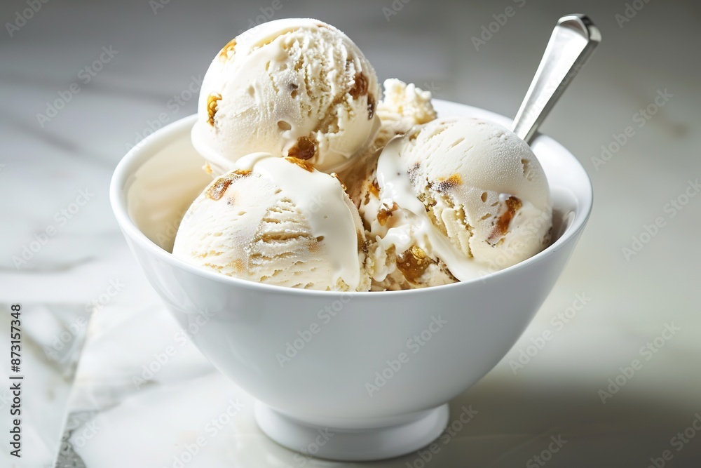 Creamy ice cream scoops in bowl with spoon on marble surface. Creamy ice cream scoops in bowl with spoon on marble surface.