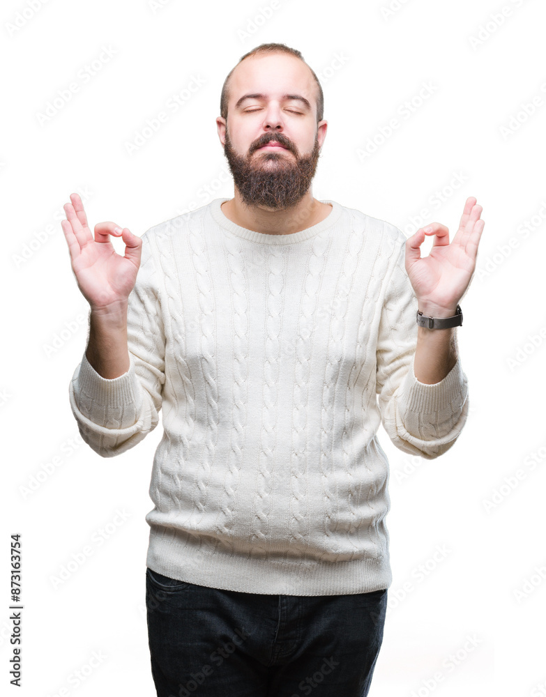 Young caucasian hipster man wearing winter sweater over isolated background relax and smiling with eyes closed doing meditation gesture with fingers. Yoga concept. Young caucasian hipster man wearing winter sweater over isolated background relax and smiling with eyes closed doing meditation gesture with fingers. Yoga concept.