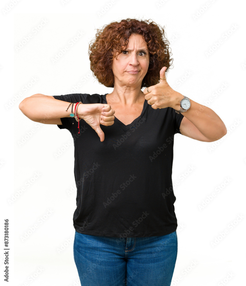Beautiful middle ager senior woman over isolated background Doing thumbs up and down, disagreement and agreement expression. Crazy conflict Beautiful middle ager senior woman over isolated background Doing thumbs up and down, disagreement and agreement expression. Crazy conflict