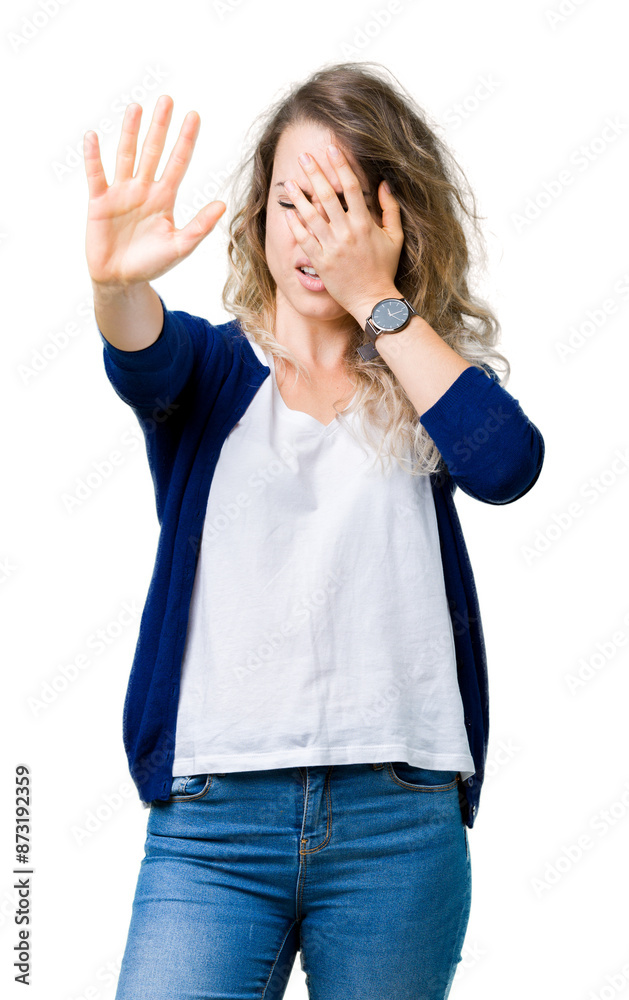 Beautiful young blonde woman over isolated background covering eyes with hands and doing stop gesture with sad and fear expression. Embarrassed and negative concept. Beautiful young blonde woman over isolated background covering eyes with hands and doing stop gesture with sad and fear expression. Embarrassed and negative concept.