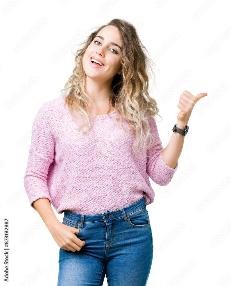 Beautiful young blonde woman over isolated background smiling with happy face looking and pointing to the side with thumb up.