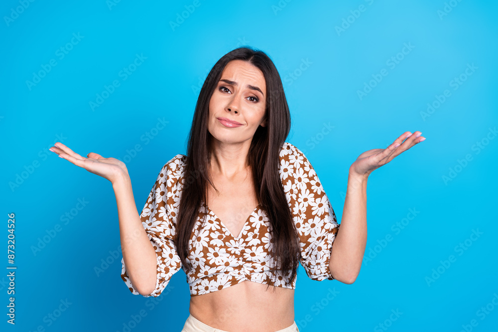 Photo of lovely cute girl wear trendy flowers print clothes shrug shoulders isolated on blue color background Photo of lovely cute girl wear trendy flowers print clothes shrug shoulders isolated on blue color background
