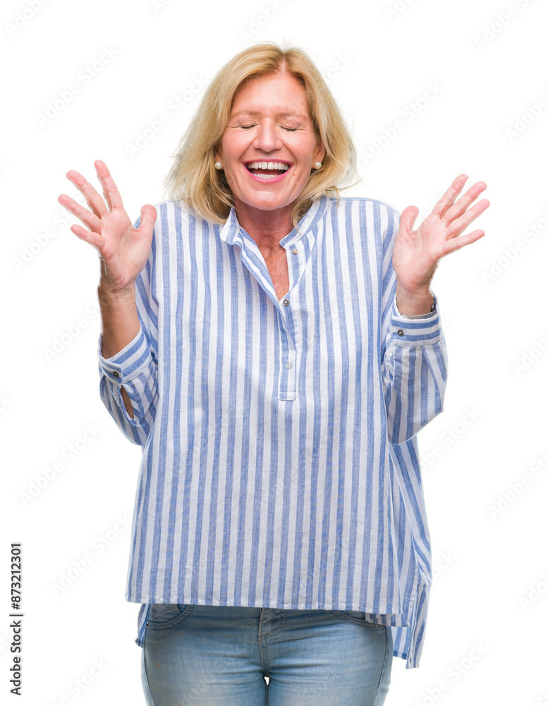 Middle age blonde business woman over isolated background celebrating mad and crazy for success with arms raised and closed eyes screaming excited. Winner concept Middle age blonde business woman over isolated background celebrating mad and crazy for success with arms raised and closed eyes screaming excited. Winner concept