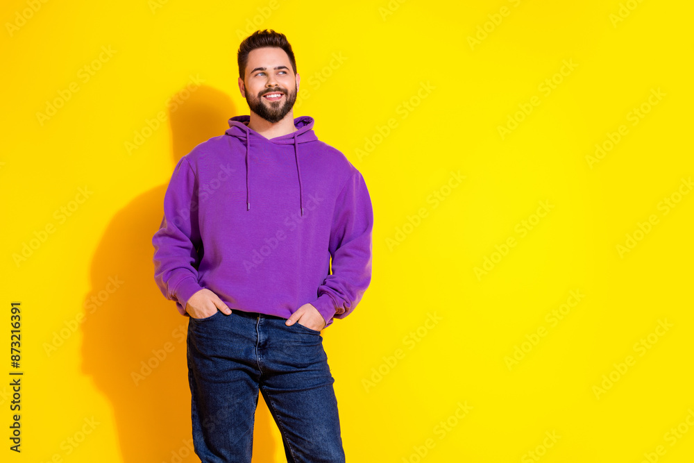 Photo of positive funny man wear violet trendy clothes look empty space banner isolated on yellow color background Photo of positive funny man wear violet trendy clothes look empty space banner isolated on yellow color background