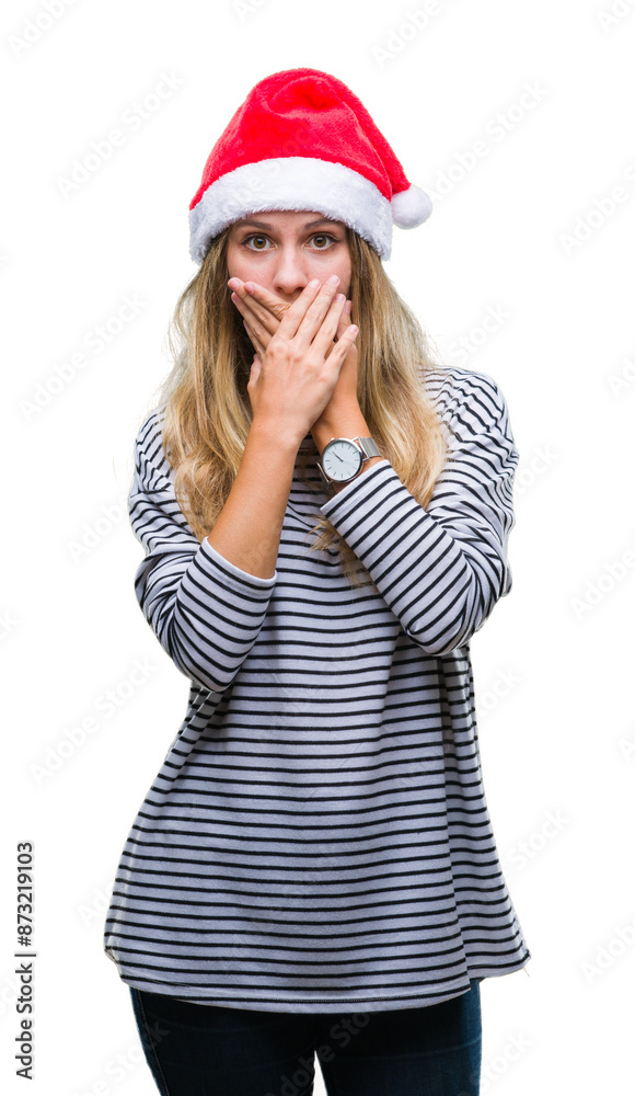 Young beautiful blonde woman wearing christmas hat over isolated background shocked covering mouth with hands for mistake. Secret concept. Young beautiful blonde woman wearing christmas hat over isolated background shocked covering mouth with hands for mistake. Secret concept.