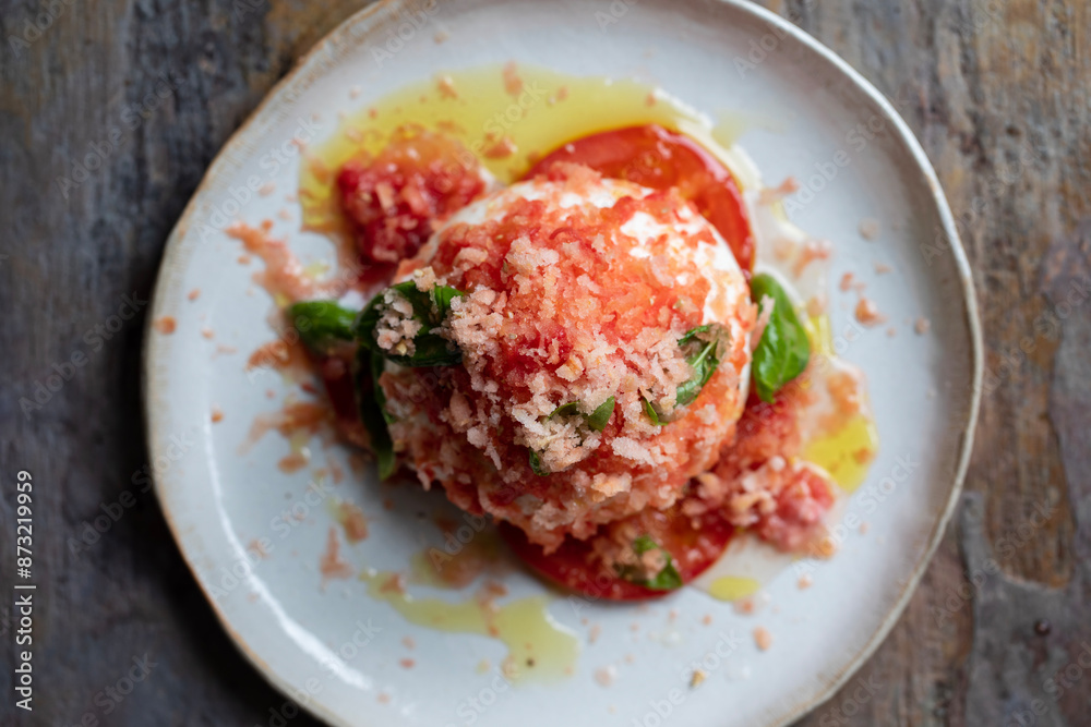 Burrata cheese with frozen tomato, basil and olive oil Burrata cheese with frozen tomato, basil and olive oil