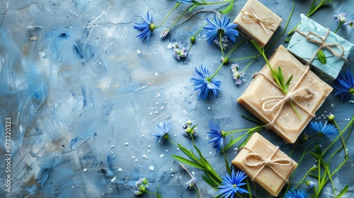 Handcrafted soap set adorned with craft paper scourge and blue flowers Emphasizing organic beauty products Overhead view with space for customization photo