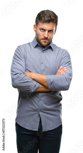 Young handsome man over isolated background skeptic and nervous, disapproving expression on face with crossed arms. Negative person.