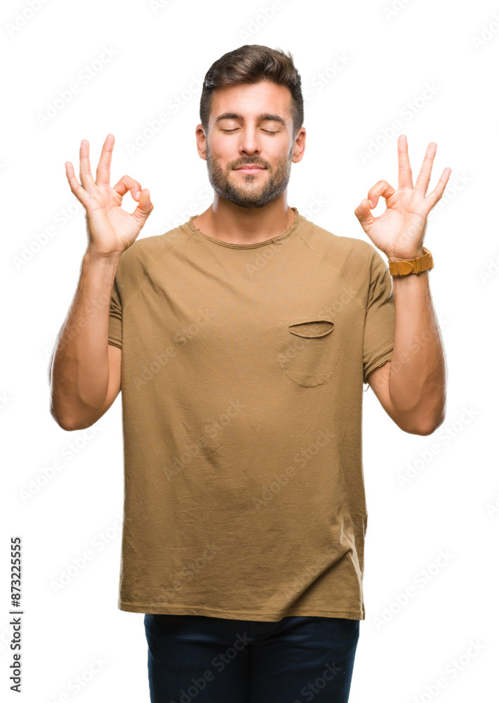 Fototapeta premium Young handsome man over isolated background relax and smiling with eyes closed doing meditation gesture with fingers. Yoga concept.