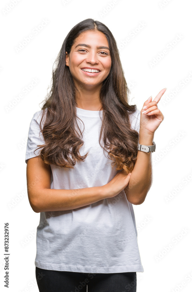 Young beautiful arab woman over isolated background with a big smile on face, pointing with hand and finger to the side looking at the camera. Young beautiful arab woman over isolated background with a big smile on face, pointing with hand and finger to the side looking at the camera.