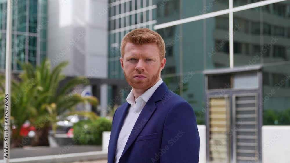 Confident redheaded businessman posing in front of modern office buildings, exuding professionalism and determination. Confident redheaded businessman posing in front of modern office buildings, exuding professionalism and determination.