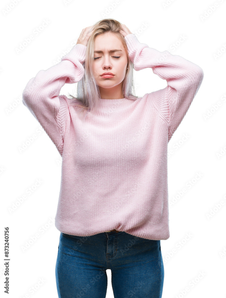 Young blonde woman wearing winter sweater over isolated background suffering from headache desperate and stressed because pain and migraine. Hands on head. Young blonde woman wearing winter sweater over isolated background suffering from headache desperate and stressed because pain and migraine. Hands on head.