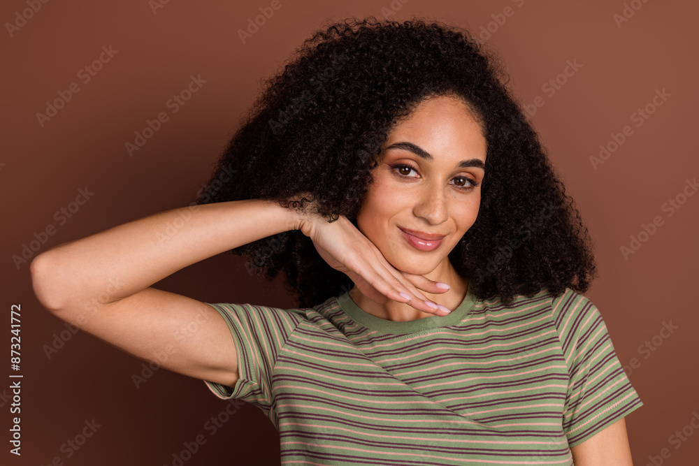 Photo of shiny attractive lady dressed striped t-shirt arm chin empty space isolated brown color background Photo of shiny attractive lady dressed striped t-shirt arm chin empty space isolated brown color background