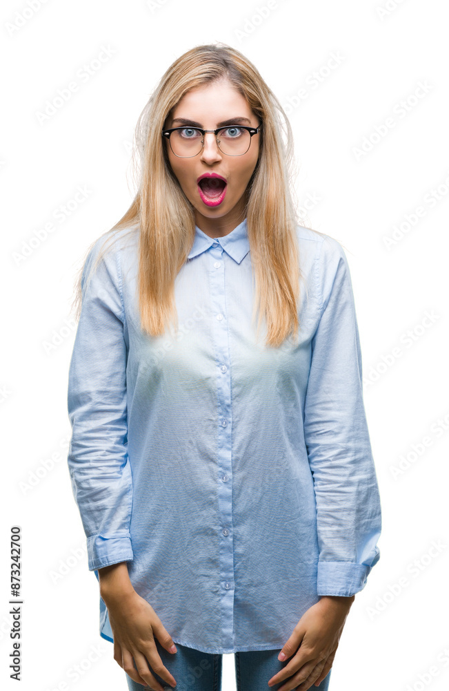 Young beautiful blonde business woman wearing glasses over isolated background afraid and shocked with surprise expression, fear and excited face. Young beautiful blonde business woman wearing glasses over isolated background afraid and shocked with surprise expression, fear and excited face.
