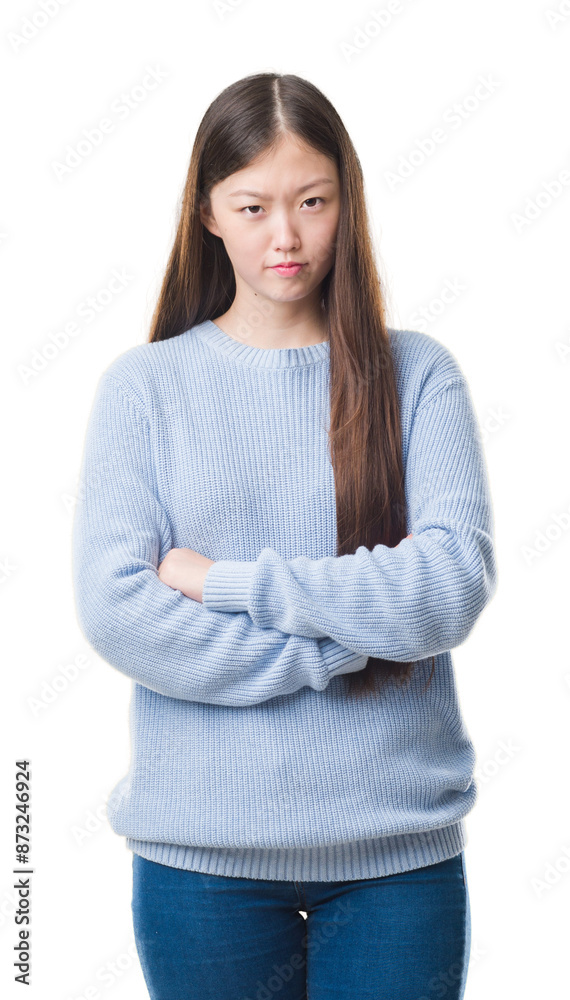 Young Chinese woman over isolated background skeptic and nervous, disapproving expression on face with crossed arms. Negative person. Young Chinese woman over isolated background skeptic and nervous, disapproving expression on face with crossed arms. Negative person.