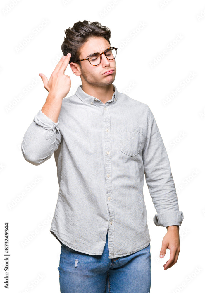 Fototapeta premium Young handsome man wearing glasses over isolated background Shooting and killing oneself pointing hand and fingers to head, suicide gesture.