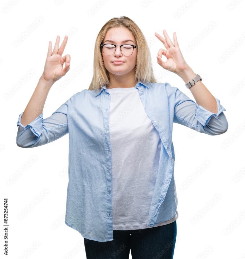 Young caucasian business woman wearing glasses over isolated background relax and smiling with eyes closed doing meditation gesture with fingers. Yoga concept. Young caucasian business woman wearing glasses over isolated background relax and smiling with eyes closed doing meditation gesture with fingers. Yoga concept.