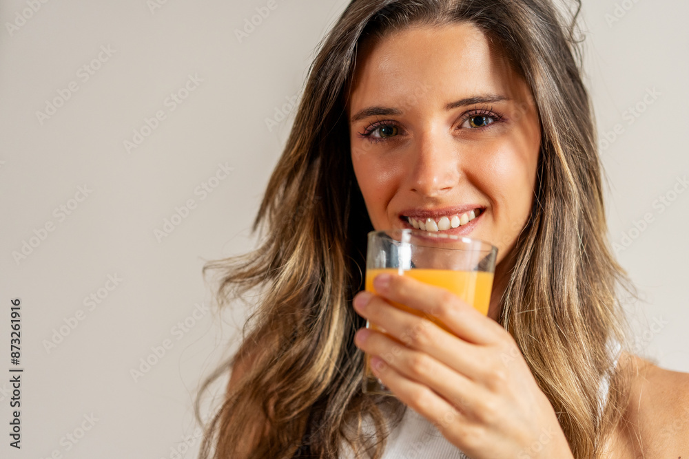 Smiling woman drinking orange juice - healthy lifestyle habits Smiling woman drinking orange juice - healthy lifestyle habits