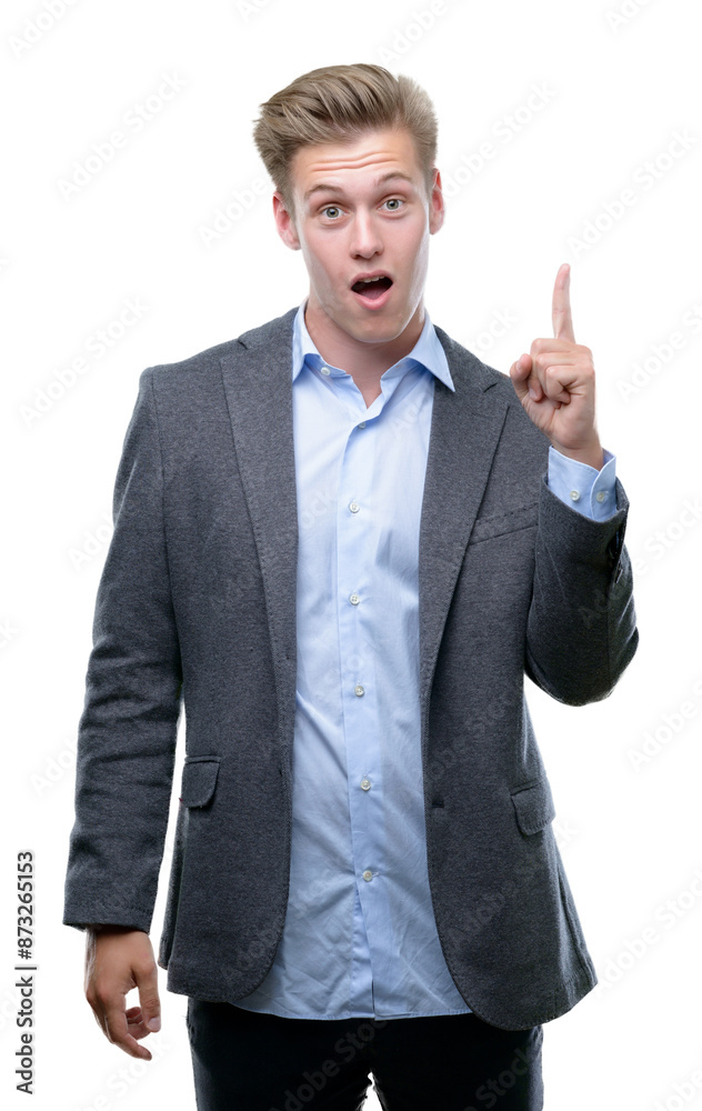 Young handsome blond business man pointing finger up with successful idea. Exited and happy. Number one. Young handsome blond business man pointing finger up with successful idea. Exited and happy. Number one.