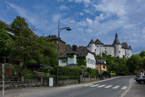 View of Clervaux Castle (Chateau de Clervaux) in Clervaux in Northern Luxembourg, dates back to XII century. Castle stands at a height of 365 meters on a rocky spur above town. Clervaux, Luxembourg. © dbrnjhrj