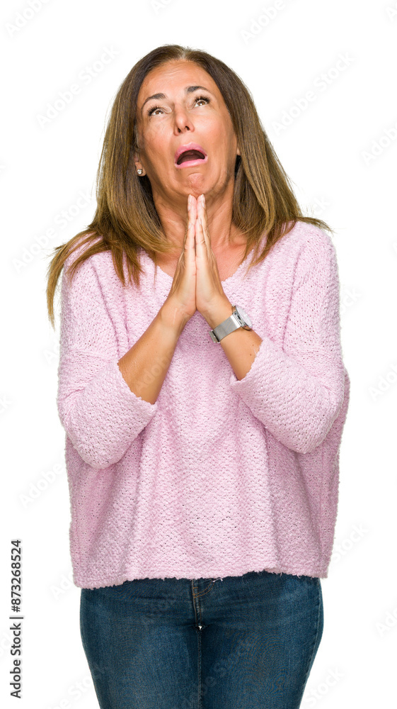 Beautiful middle age adult woman wearing winter sweater over isolated background begging and praying with hands together with hope expression on face very emotional and worried. Asking for forgiveness