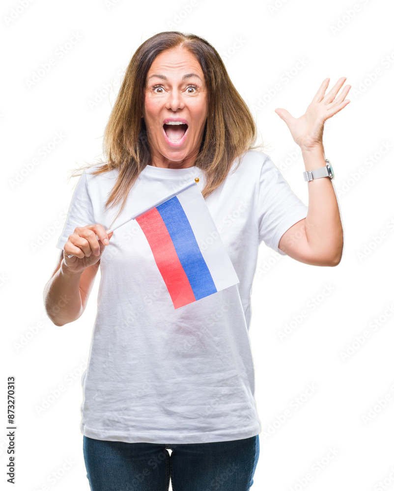 Middle age hispanic woman holding flag of Russia over isolated background very happy and excited, winner expression celebrating victory screaming with big smile and raised hands Middle age hispanic woman holding flag of Russia over isolated background very happy and excited, winner expression celebrating victory screaming with big smile and raised hands