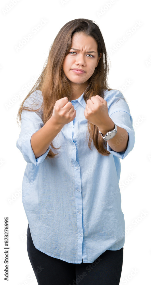 Young beautiful brunette business woman over isolated background Ready to fight with fist defense gesture, angry and upset face, afraid of problem