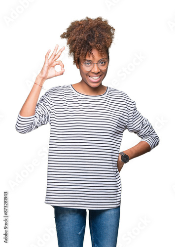 Beautiful young african american woman wearing glasses over isolated background smiling positive doing ok sign with hand and fingers. Successful expression.