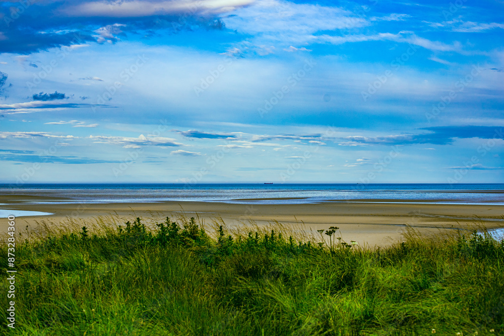 Dublin, Ireland - wetland beach under blue sky and white clouds Dublin, Ireland - wetland beach under blue sky and white clouds