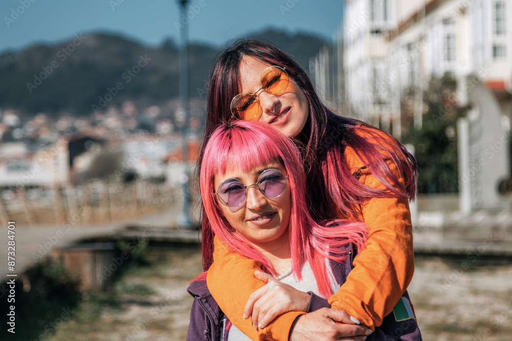couple of loving lesbian women hugging on the street couple of loving lesbian women hugging on the street