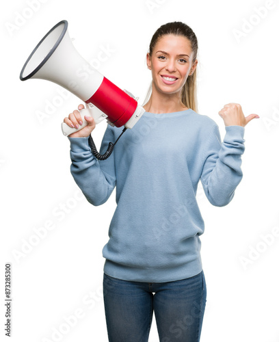 Beautiful young woman holding megaphone pointing with hand and finger up with happy face smiling