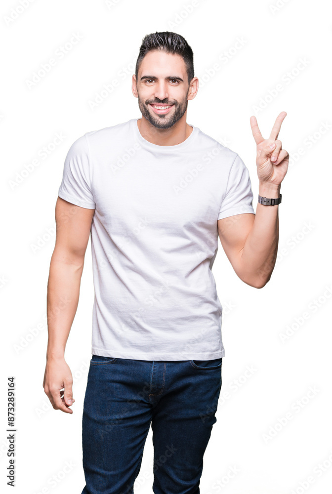 Young man wearing casual white t-shirt over isolated background smiling with happy face winking at the camera doing victory sign. Number two.