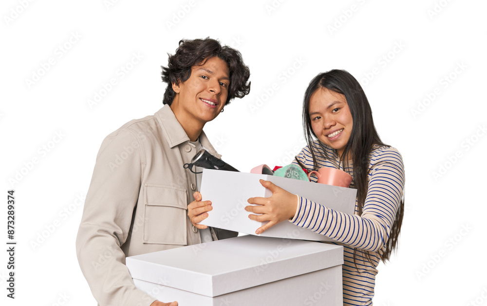 Multiracial young couple with moving boxes in studio Multiracial young couple with moving boxes in studio