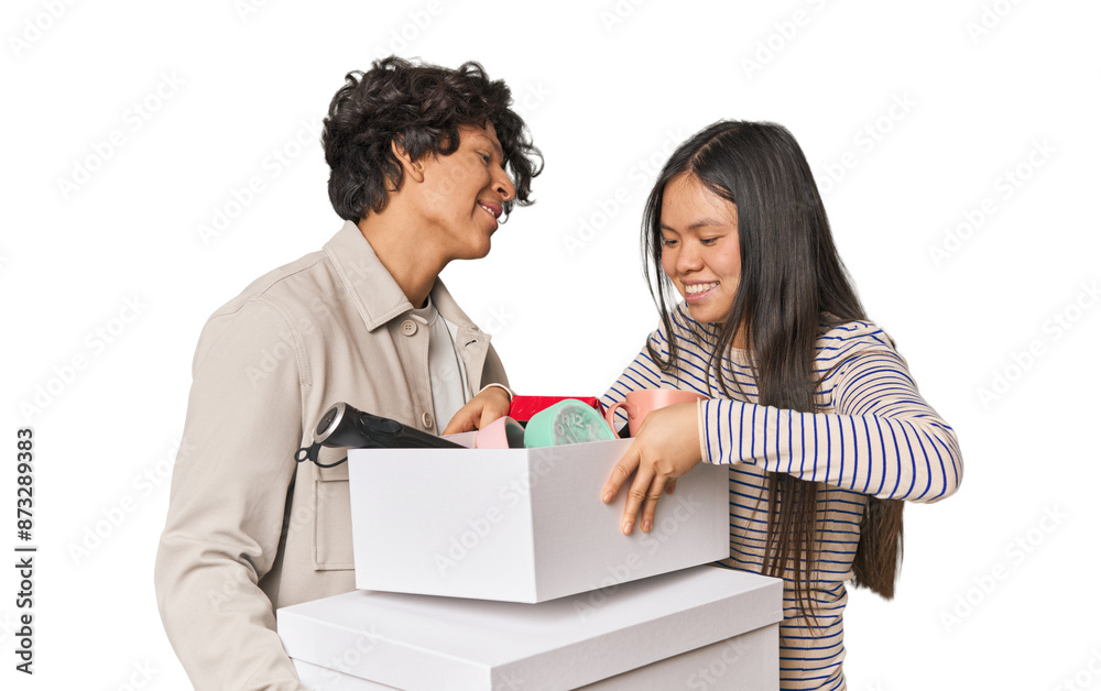 Multiracial young couple with moving boxes in studio Multiracial young couple with moving boxes in studio