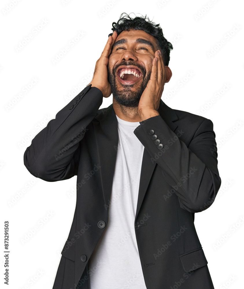 Hispanic businessman in suit in studio laughs joyfully keeping hands on head. Happiness concept. Hispanic businessman in suit in studio laughs joyfully keeping hands on head. Happiness concept.