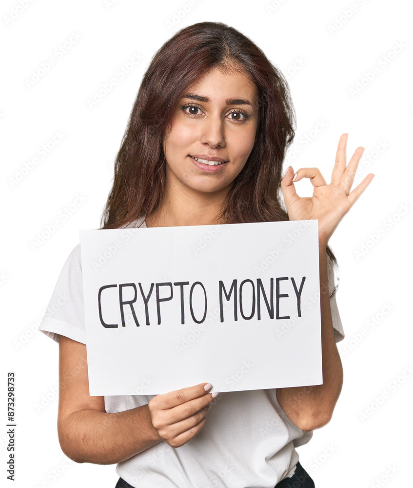 Middle Eastern woman with crypto sign cheerful and confident showing ok gesture. Middle Eastern woman with crypto sign cheerful and confident showing ok gesture.