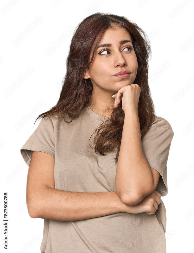 Middle Eastern woman in studio thinking and looking up, being reflective, contemplating, having a fantasy. Middle Eastern woman in studio thinking and looking up, being reflective, contemplating, having a fantasy.