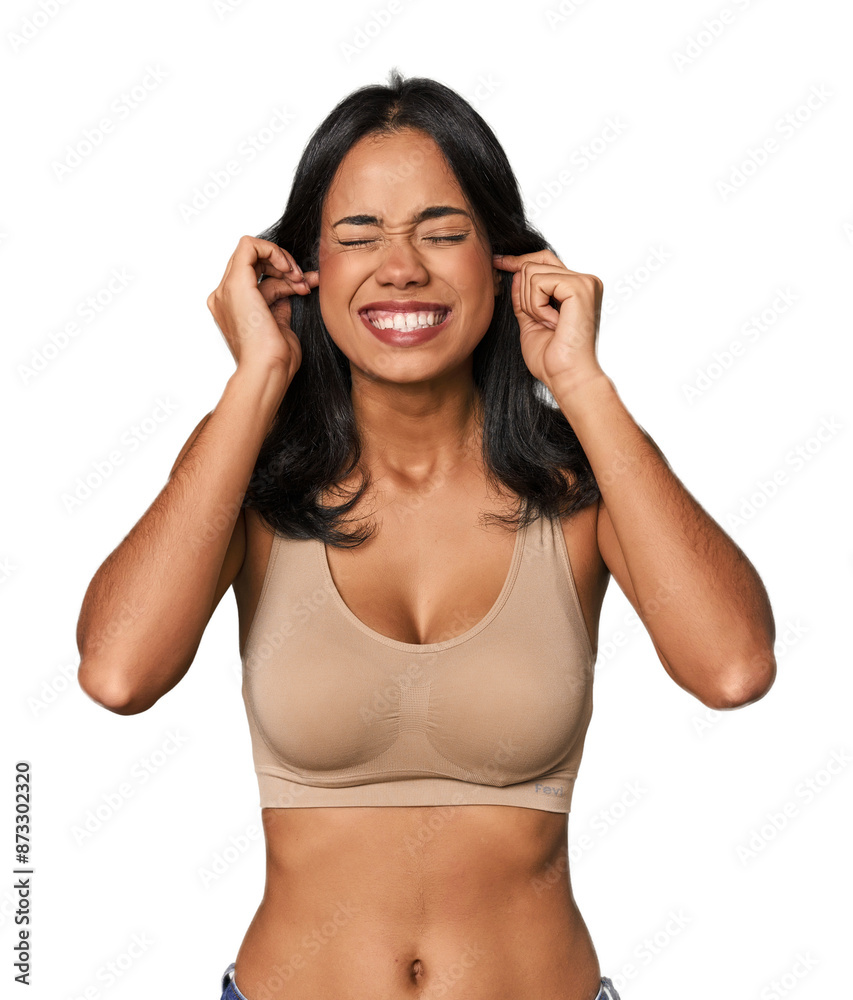 Young Filipino woman in light wear covering ears with hands. Young Filipino woman in light wear covering ears with hands.