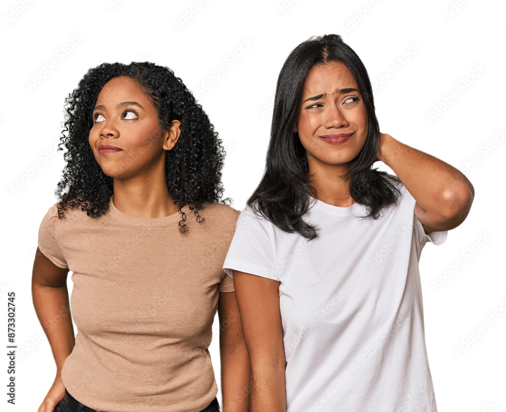 Young Latin friends in studio touching back of head, thinking and making a choice. Young Latin friends in studio touching back of head, thinking and making a choice.